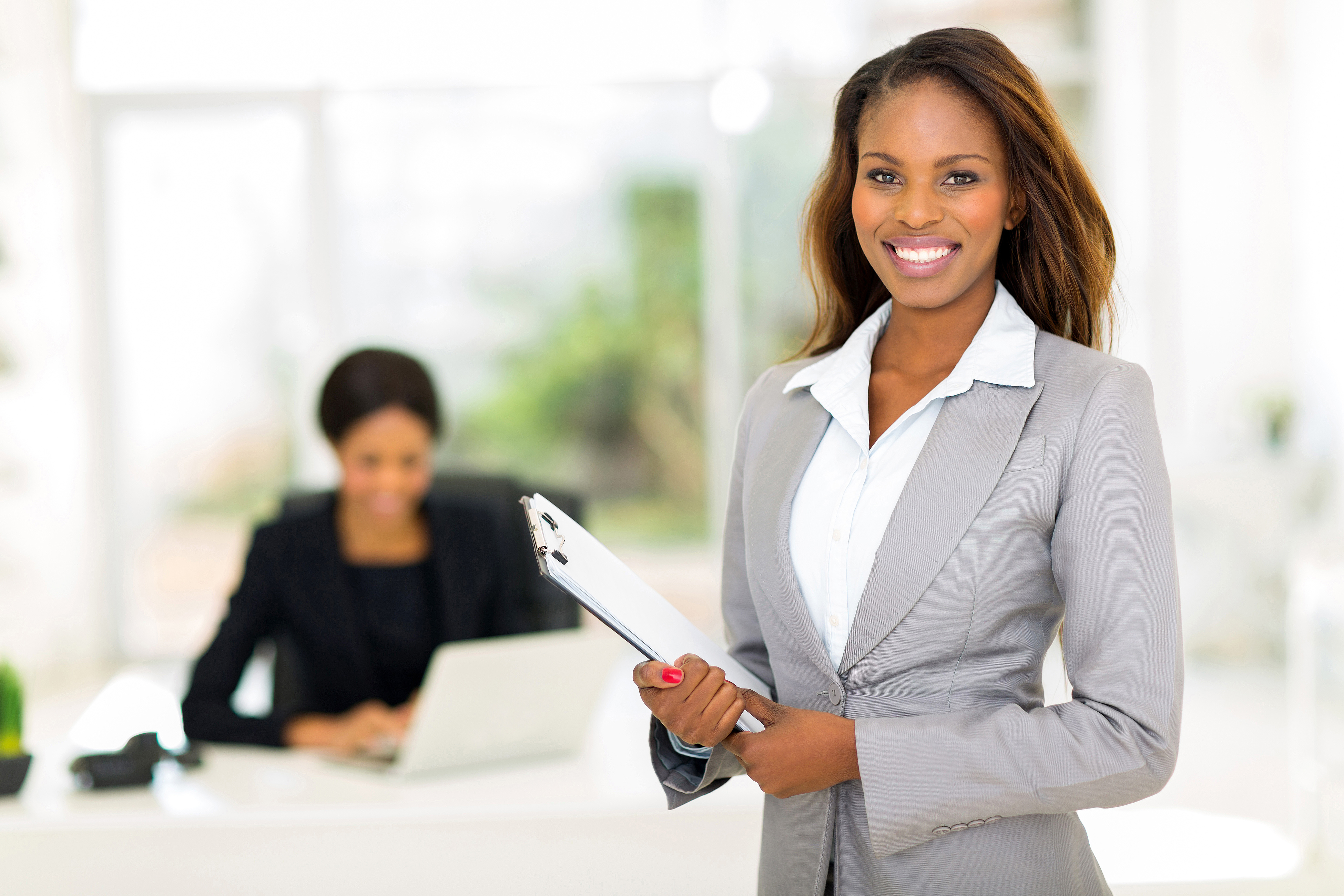 beautiful african businesswoman holding clipboard